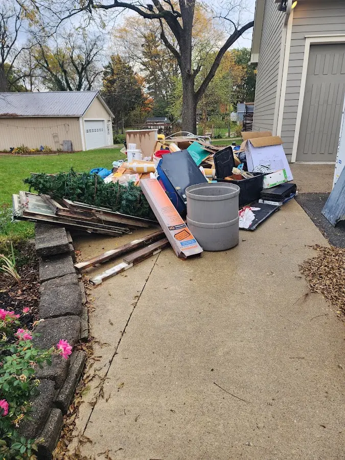 Dumpster being loaded with debris for Estate Cleanout Dumpster Rental in Zanesville